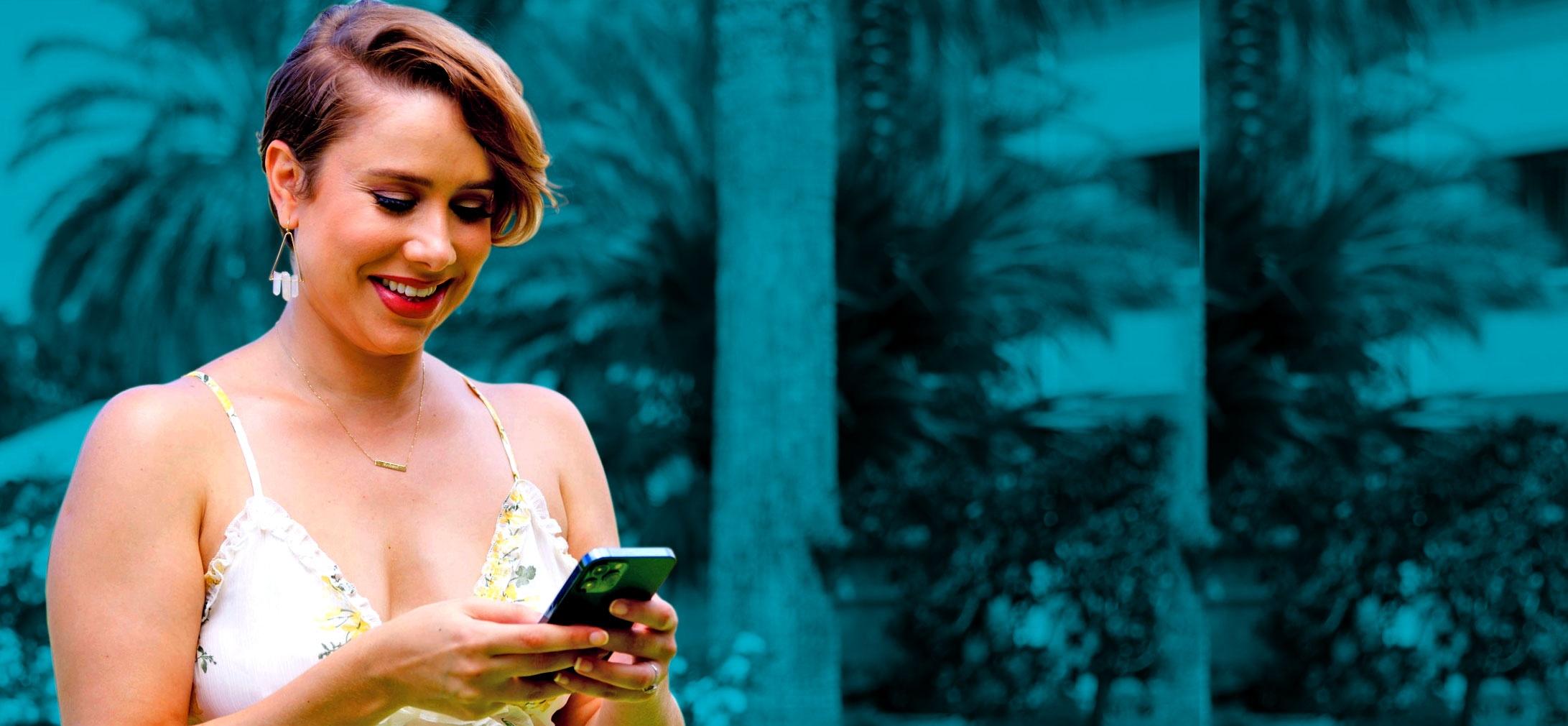 Women smiling while looking at her smartphone 
